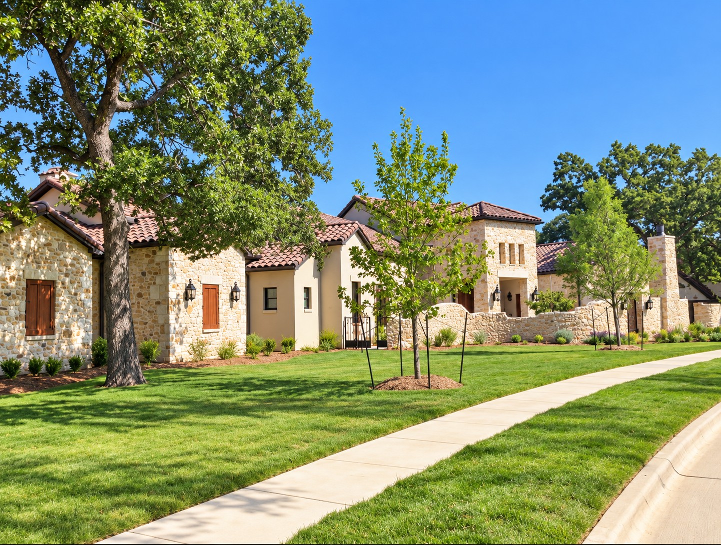 Stone home and lawn with curving sidewalk