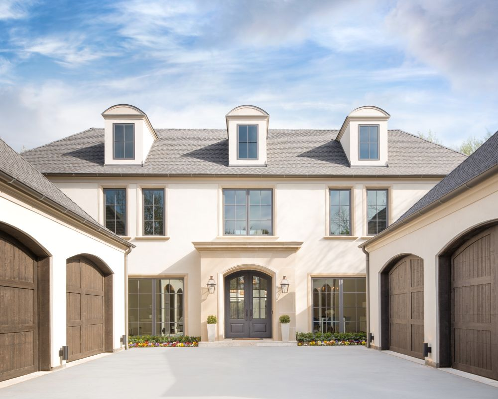 Stucco courtyard elevation with wood garage doors and dormer windows